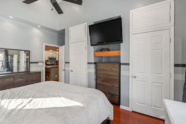 bedroom with ceiling fan and dark hardwood / wood-style flooring