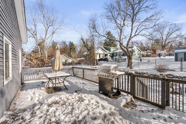 snow covered deck featuring area for grilling