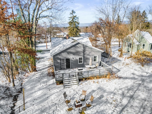 snow covered property featuring a wooden deck