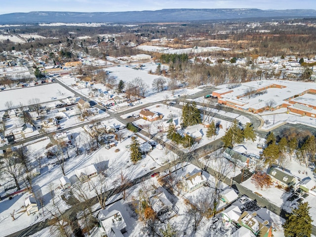 snowy aerial view with a mountain view