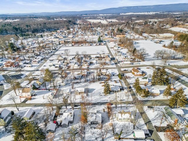 snowy aerial view with a mountain view