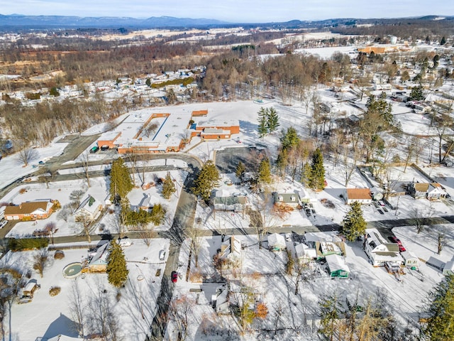 snowy aerial view with a mountain view