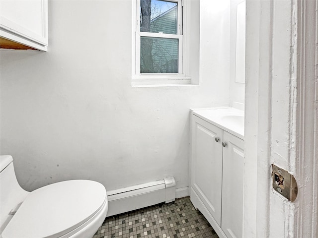 bathroom featuring tile patterned floors, vanity, toilet, and a baseboard heating unit