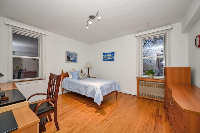 bedroom featuring radiator and light wood-type flooring