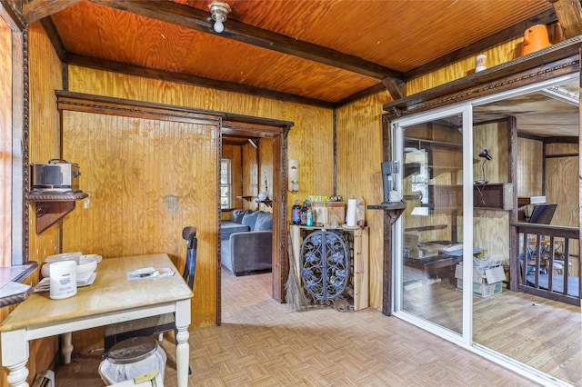 interior space with beam ceiling, light parquet flooring, wood ceiling, and wood walls