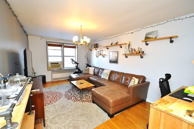 living room featuring radiator heating unit, an inviting chandelier, cooling unit, and hardwood / wood-style floors