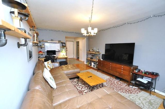 living room featuring a chandelier and wood-type flooring