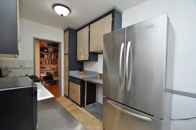 kitchen with tasteful backsplash, stainless steel refrigerator, and light tile patterned flooring