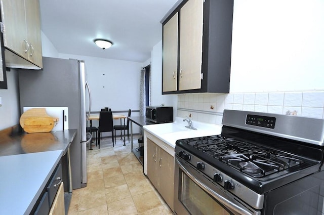 kitchen with stainless steel appliances, tasteful backsplash, and light tile patterned flooring