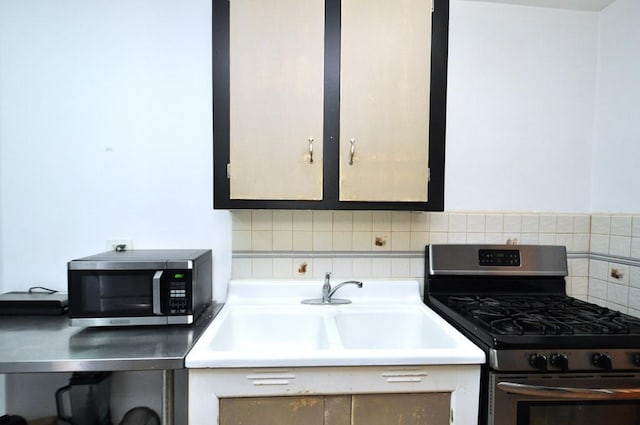 kitchen featuring appliances with stainless steel finishes, tasteful backsplash, and sink