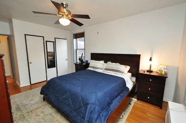 bedroom with ceiling fan and light hardwood / wood-style floors