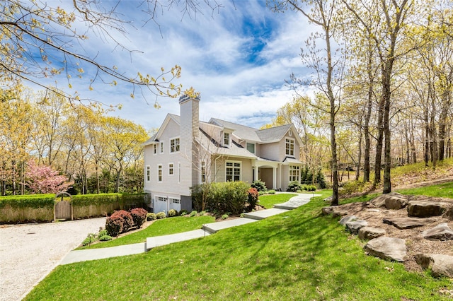 view of home's exterior with a garage and a lawn