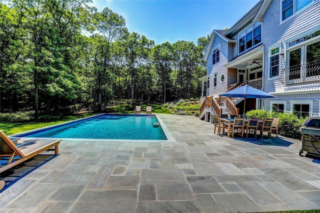 view of pool with a patio, ceiling fan, and grilling area