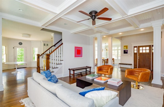 living room with beamed ceiling, ornamental molding, dark wood-type flooring, and coffered ceiling