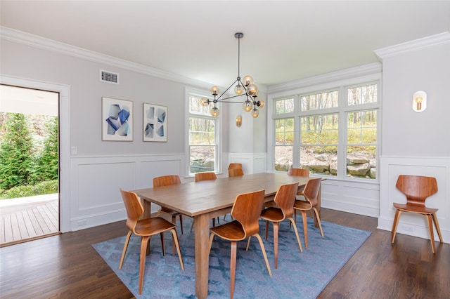 dining room with crown molding, a healthy amount of sunlight, and dark hardwood / wood-style floors