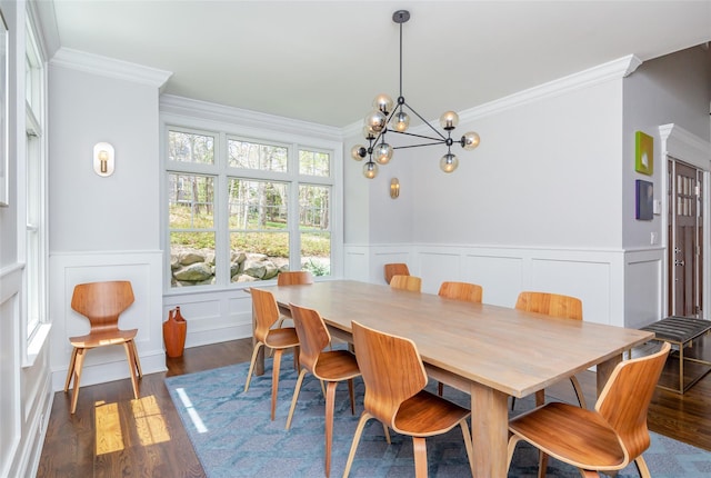 dining space featuring dark hardwood / wood-style floors, an inviting chandelier, and crown molding