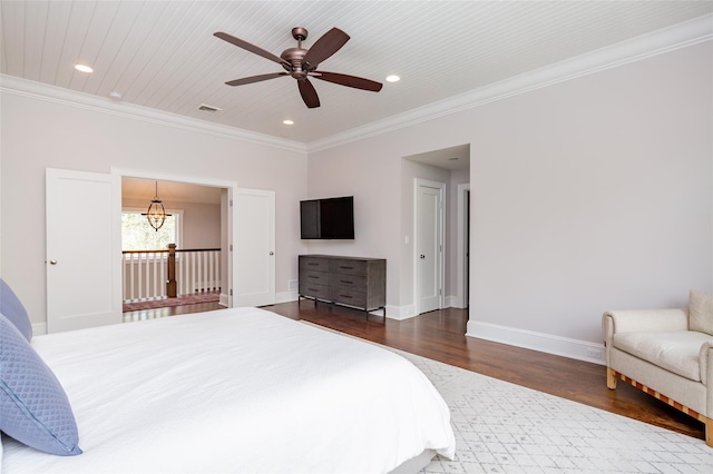 bedroom featuring ceiling fan, dark hardwood / wood-style floors, access to exterior, and ornamental molding