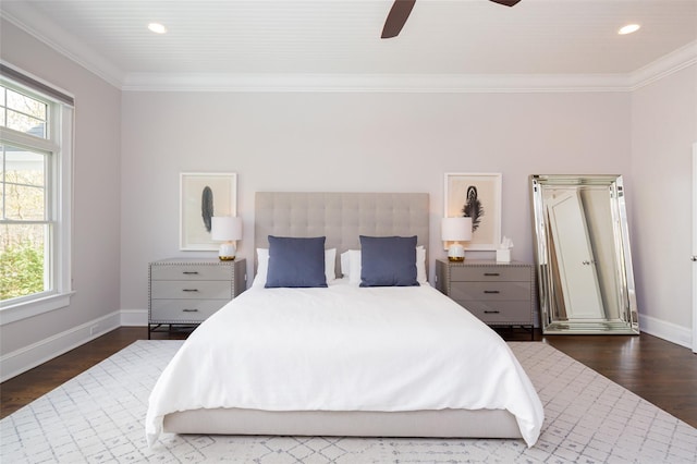 bedroom featuring dark hardwood / wood-style flooring, ceiling fan, and ornamental molding