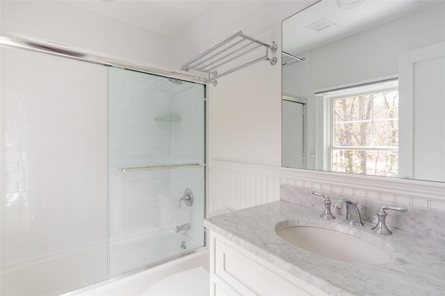 full bathroom with vanity, toilet, and enclosed tub / shower combo