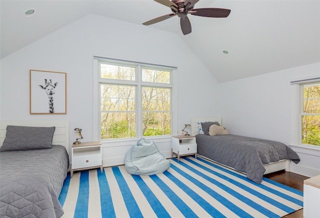 bedroom with ceiling fan, dark hardwood / wood-style flooring, and vaulted ceiling