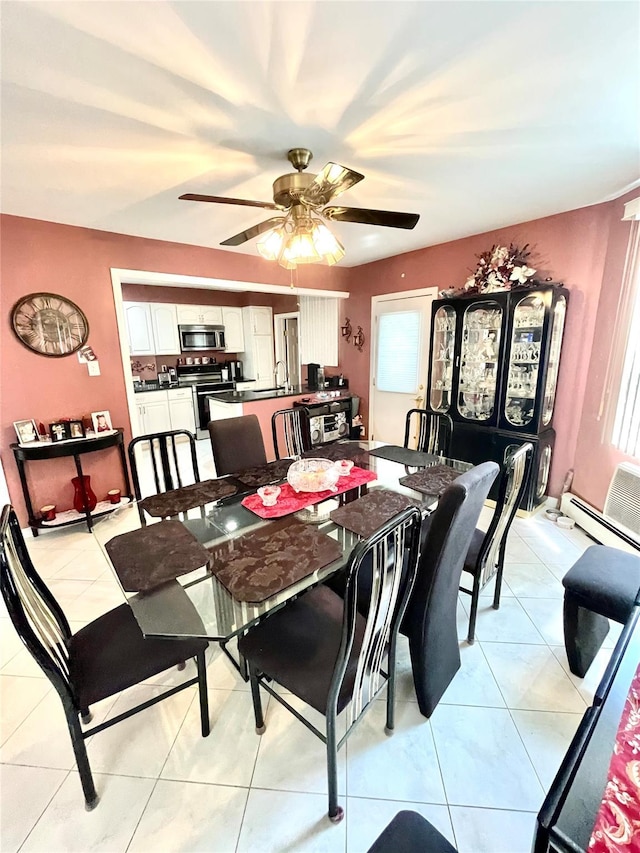 dining area with ceiling fan, light tile patterned floors, and sink