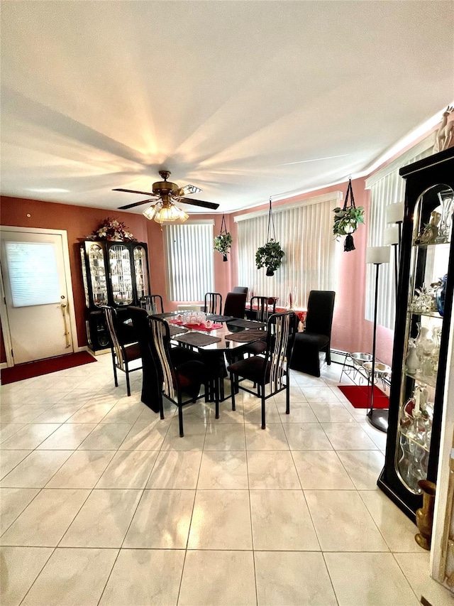 tiled dining area with a wealth of natural light and ceiling fan