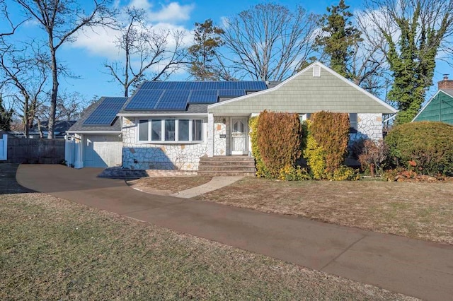 single story home featuring solar panels