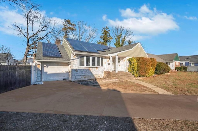 ranch-style home with solar panels