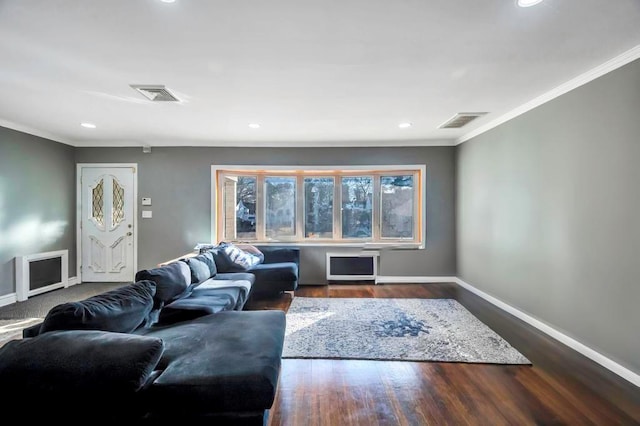 living room featuring hardwood / wood-style flooring and crown molding