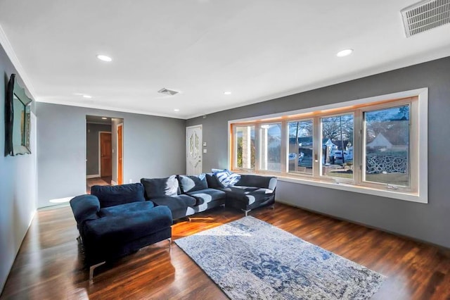 living room featuring dark wood-type flooring and ornamental molding