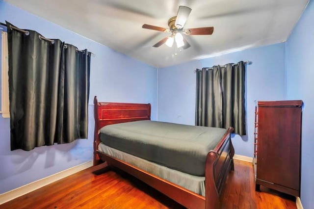 bedroom with ceiling fan and hardwood / wood-style floors