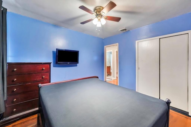 unfurnished bedroom with a closet, ceiling fan, and dark wood-type flooring