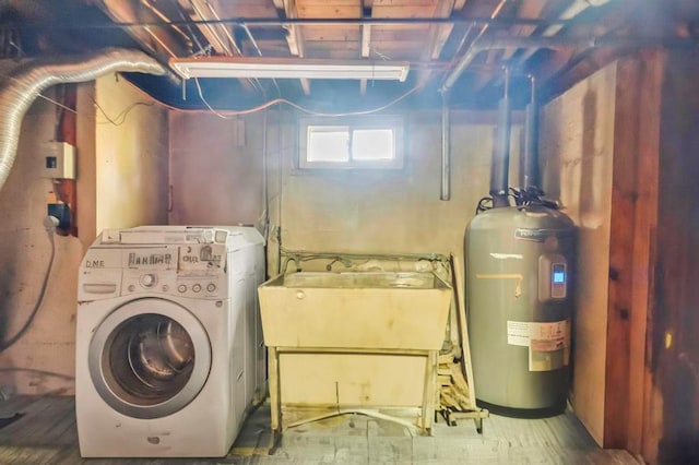 laundry area with electric water heater, washer / clothes dryer, and sink