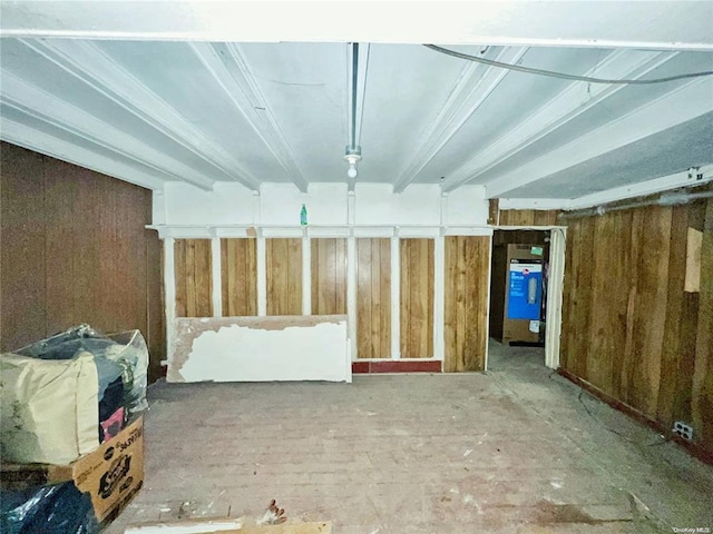 basement featuring wooden walls