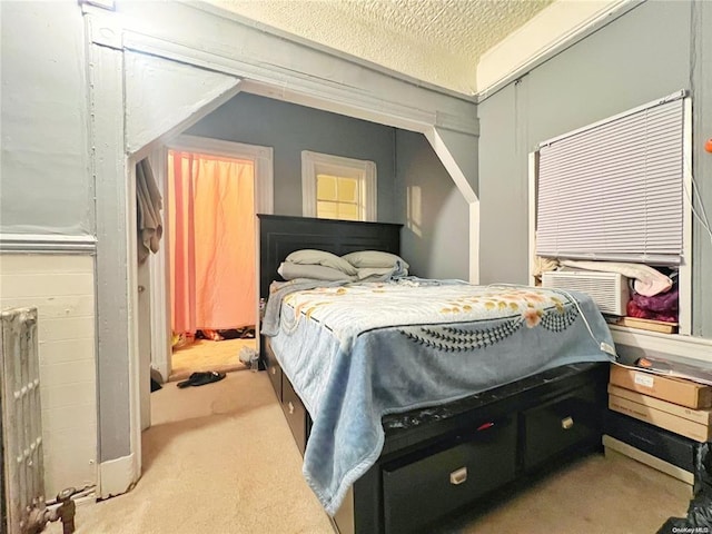 bedroom featuring light colored carpet and a textured ceiling