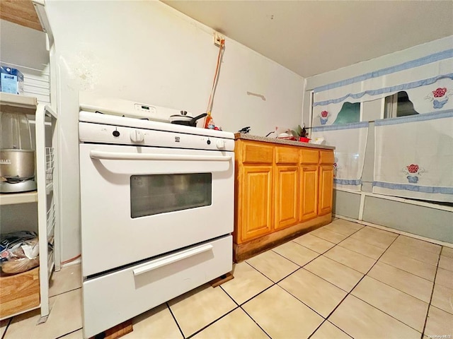 kitchen with light tile patterned floors and white range