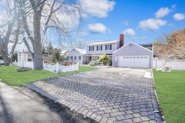 front facade with a front yard and a garage