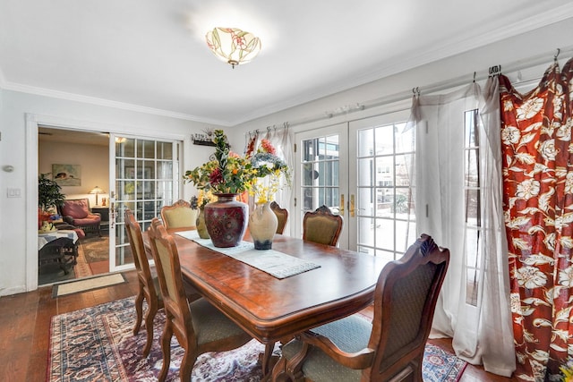 dining space with french doors, crown molding, and wood-type flooring