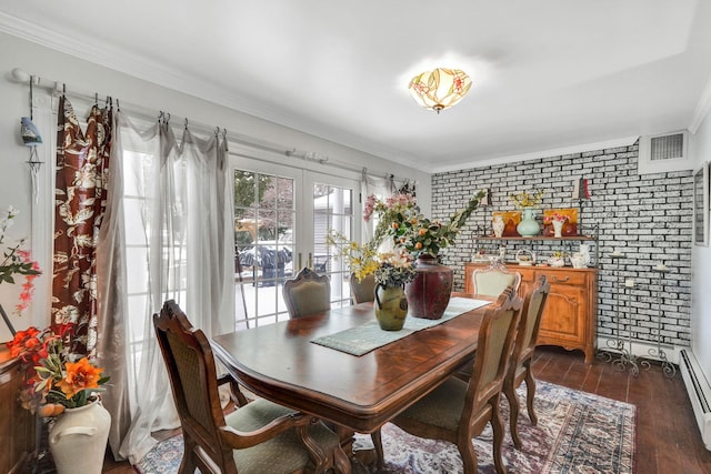 dining area with french doors, brick wall, dark hardwood / wood-style floors, and ornamental molding