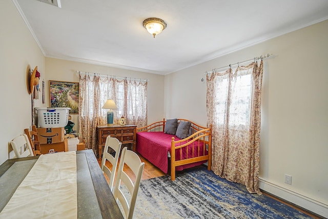 bedroom with hardwood / wood-style flooring, baseboard heating, multiple windows, and crown molding