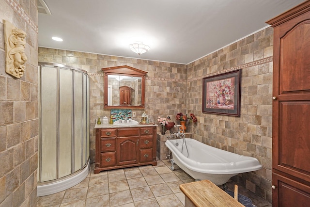 bathroom featuring tile patterned floors, vanity, tile walls, and independent shower and bath