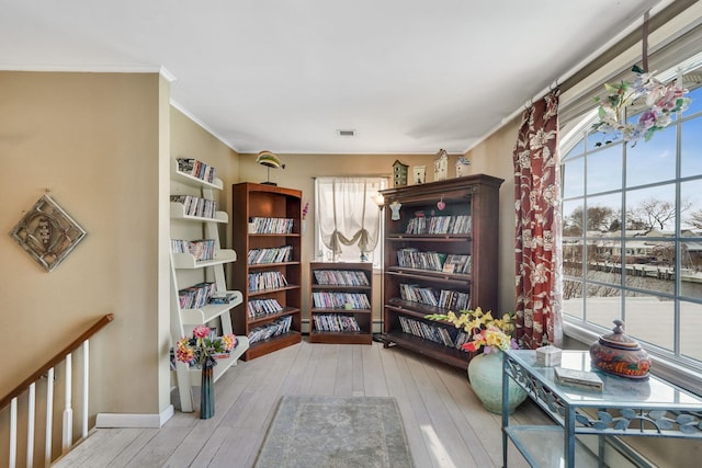 sitting room featuring light hardwood / wood-style floors and crown molding