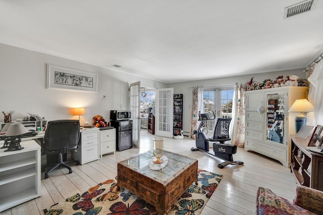 living room featuring french doors and light hardwood / wood-style flooring