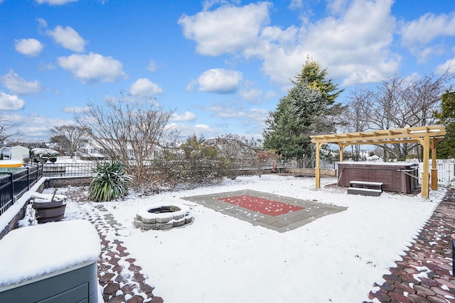 yard covered in snow featuring a pergola, an outdoor fire pit, and a hot tub