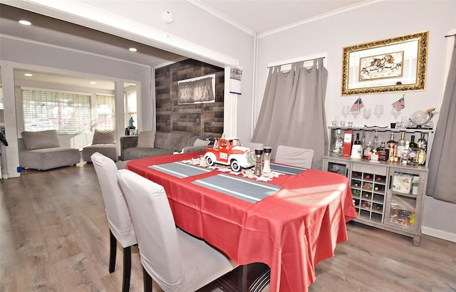 dining room featuring crown molding and hardwood / wood-style floors