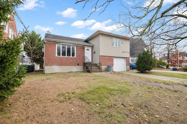 view of front of home with a front yard and a garage