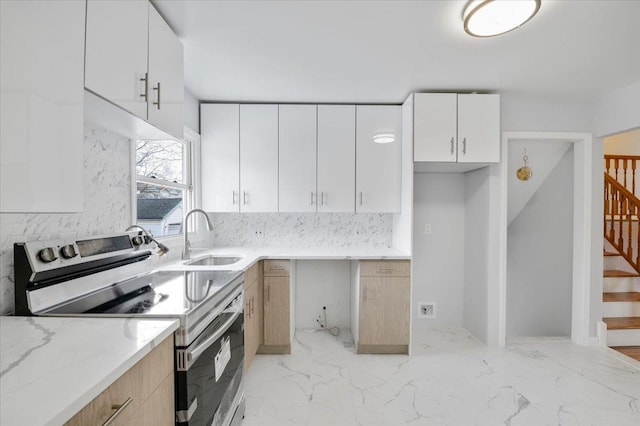 kitchen featuring tasteful backsplash, light stone counters, sink, white cabinets, and stainless steel electric range oven