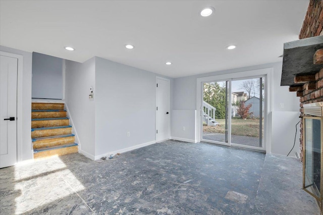 unfurnished living room with a brick fireplace