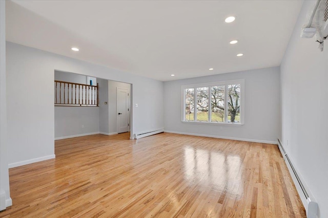 spare room featuring light hardwood / wood-style flooring and a baseboard heating unit