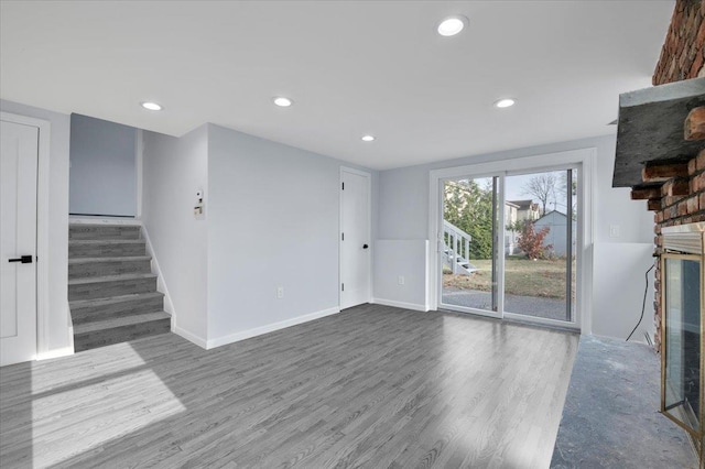 unfurnished living room featuring a large fireplace and hardwood / wood-style flooring